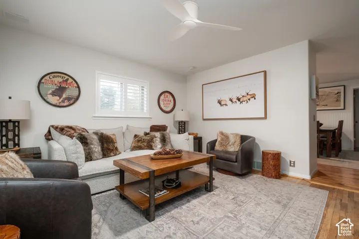 Hardwood flooring, plantation shutters, recessed lighting, and an open doorway