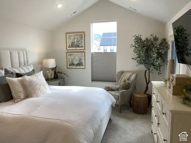 Vaulted ceiling, recessed lighting, and a large window with privacy blinds