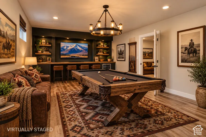 Built-in bar cabinetry with integrated shelving, dark-finish wood-finish flooring, metal industrial-style chandelier, and recessed lighting