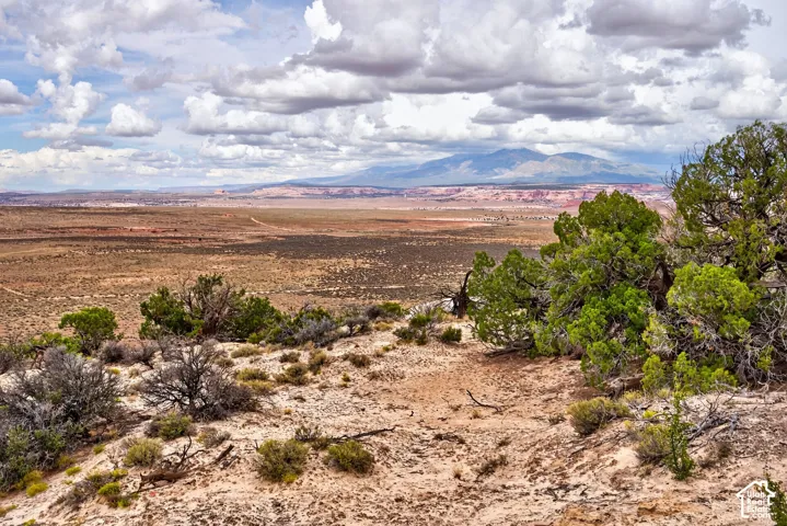 Expansive desert landscape with natural terrain and distant mountains