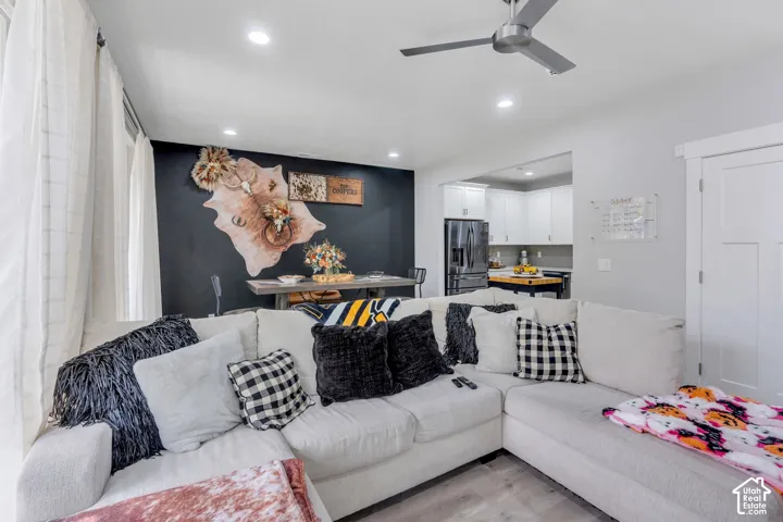 Living space featuring wood-finish flooring, recessed lighting, and a modern ceiling fan