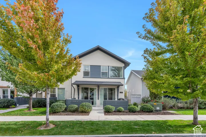 Two-story exterior featuring a neutral stucco and lap siding fa