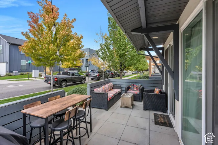 Covered patio featuring concrete pavers, horizontal wood-panel privacy fencing, and recessed lighting