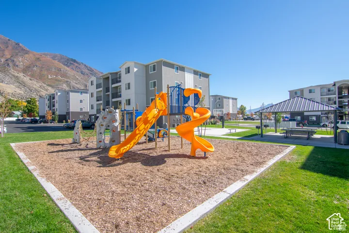 Outdoor recreation area featuring a playground, picnic pavilion & sport court