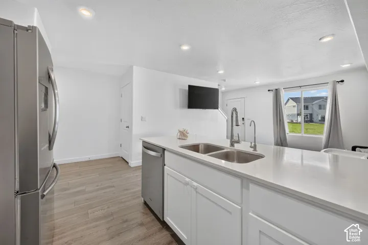 Modern kitchen island with a double basin sink, stainless steel faucet, and white countertop