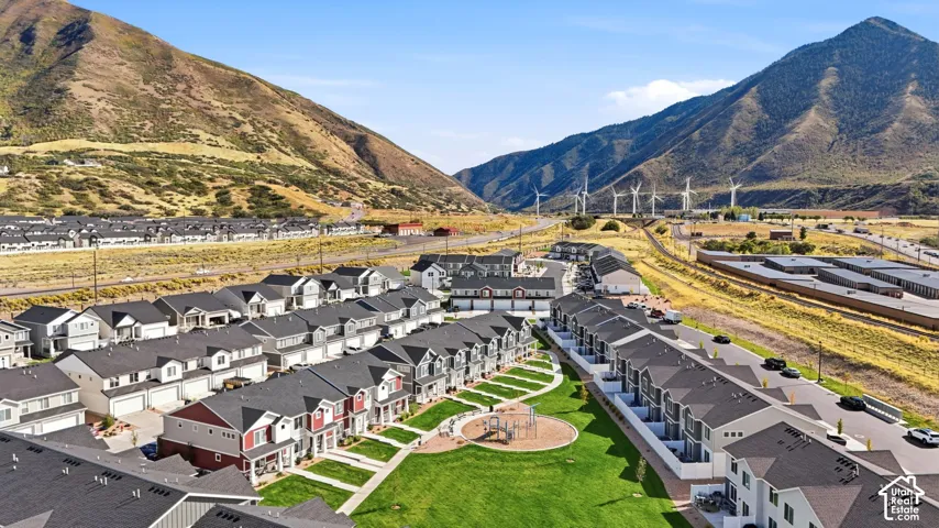 Community green space with playground equipment, surrounded by townhome-style residences