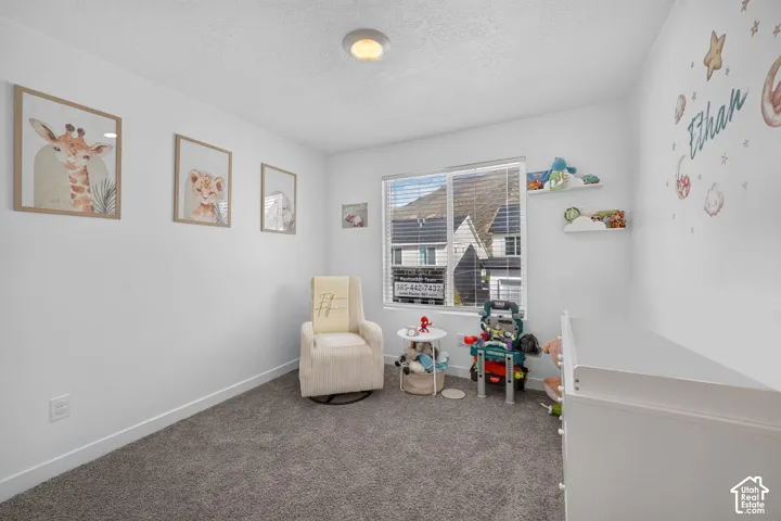 Recessed lighting, white walls, gray carpet flooring, and a window with horizontal blinds