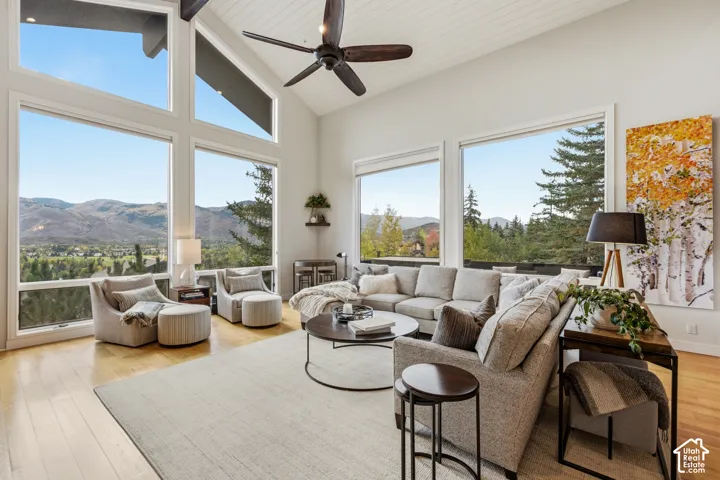 Vaulted wood-paneled ceiling, expansive windows, wood-finish flooring, and recessed lighting