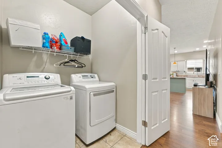 Main floor laundry closet featuring tile flooring, neutral wall paint, and overhead wire shelving