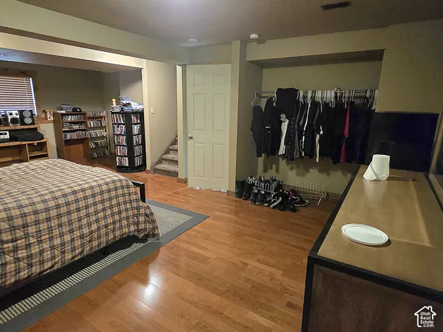Room featuring wood-finish flooring, recessed lighting, and a six-panel door