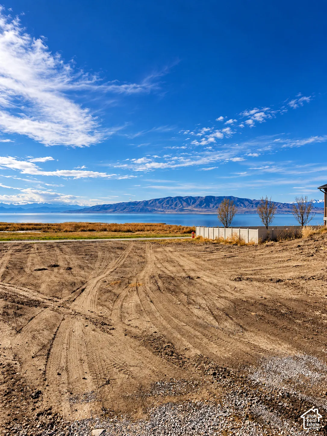 Cleared vacant lot featuring lakefront view and prominent mountain scenery