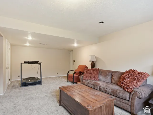 Interior space featuring neutral wall tones, wall-to-wall carpeting, and recessed lighting