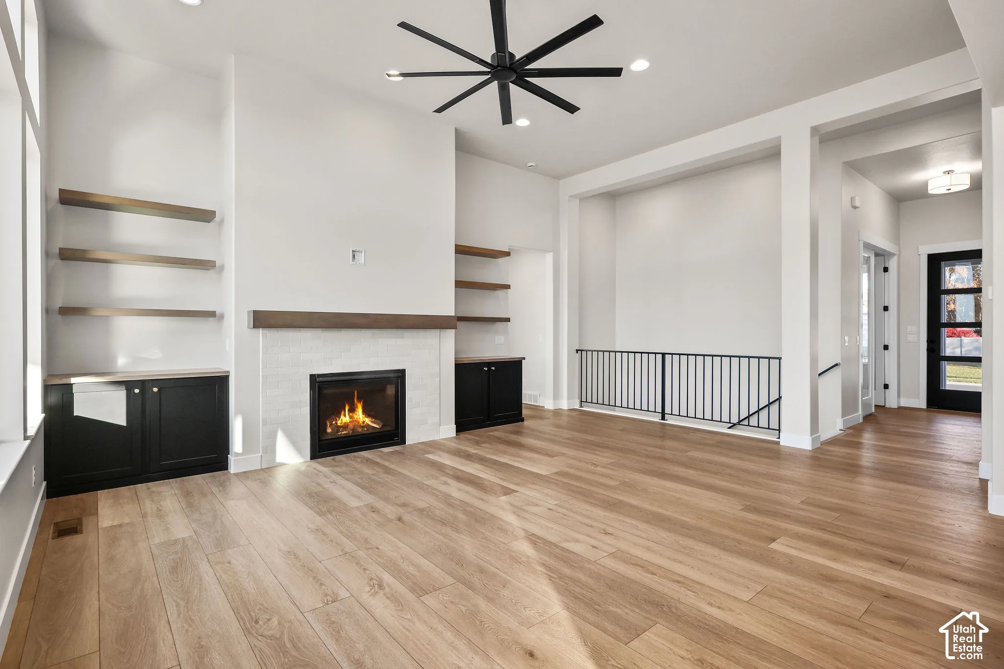 Living area featuring a modern fireplace with a light tile surround and dark wood mantle