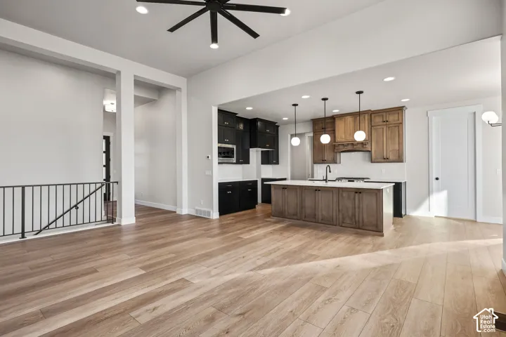 Open-concept living area featuring wood-finish flooring and a contemporary kitchen