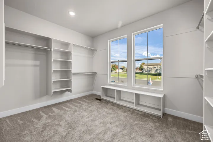 Built-in closet system with multiple shelving units and hanging rods