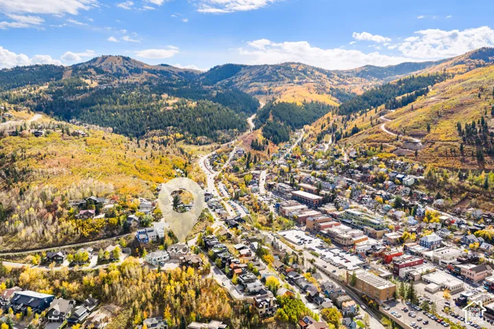 Aerial perspective featuring mountainous terrain, mature aspen forest, and proximity to the commercial district