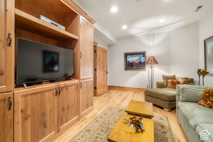 Custom built-in wood cabinetry, wood-finish flooring, and solid wood door with dark hardware