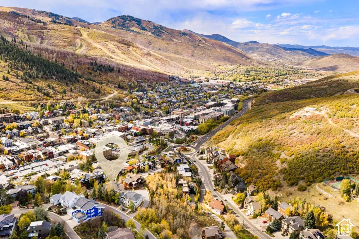 Aerial perspective featuring extensive mountain range topography, valley terrain, and mature foliage