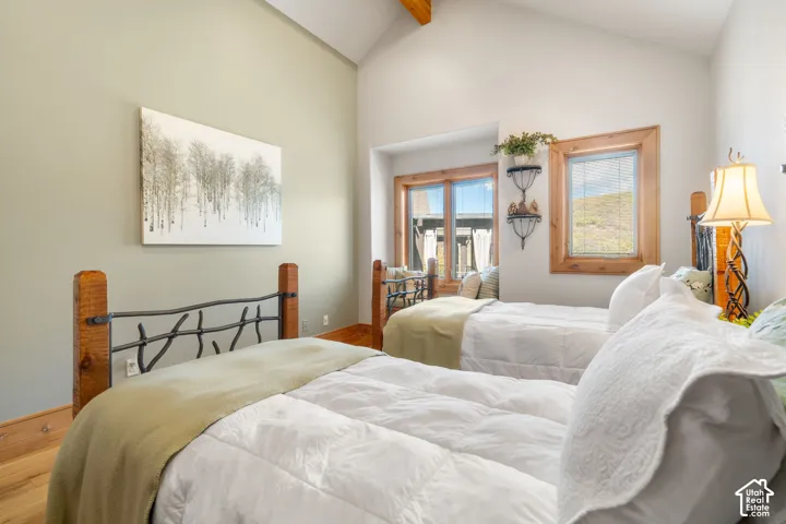Vaulted ceilings, wood-finish flooring, wood-framed windows, and natural wood trim accents