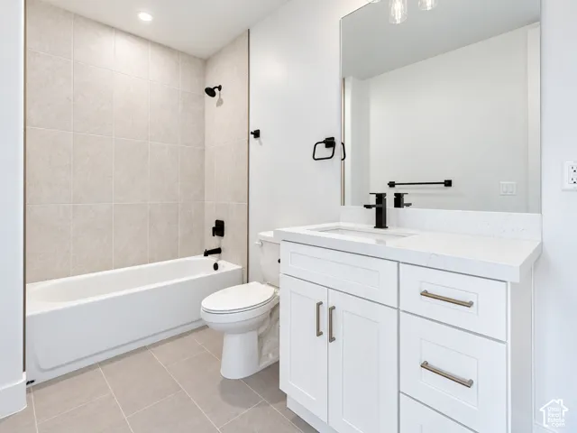 Guest Suite Bathroom not staged featuring a white vanity cabinet with quartz countertop, undermount sink, and full-width mirror