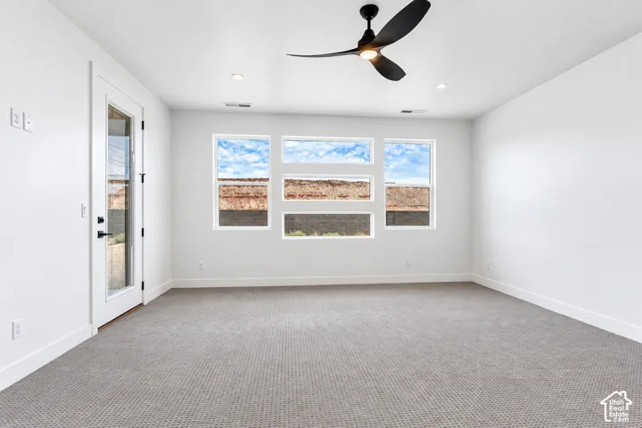 Primary Bedroom, not staged. Neutral-toned carpeting, multi-pane window configuration, and glass-paneled exterior door