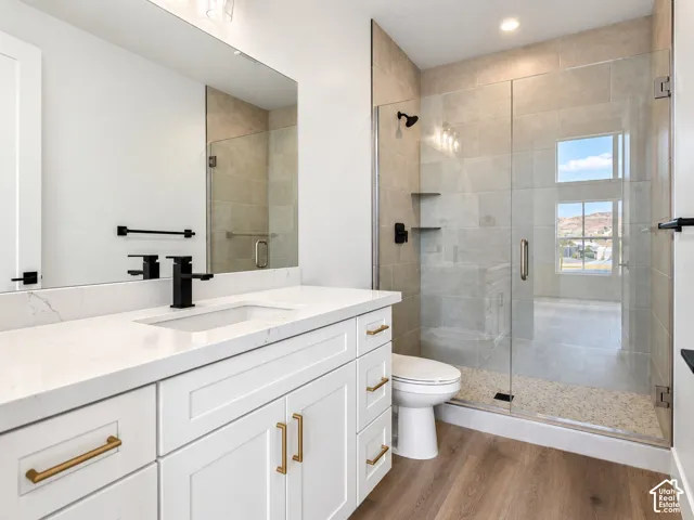 Casita bathroom featuring white cabinetry, solid-surface countertop, and a walk-in shower with floor-to-ceiling tile surround and glass enclosure.