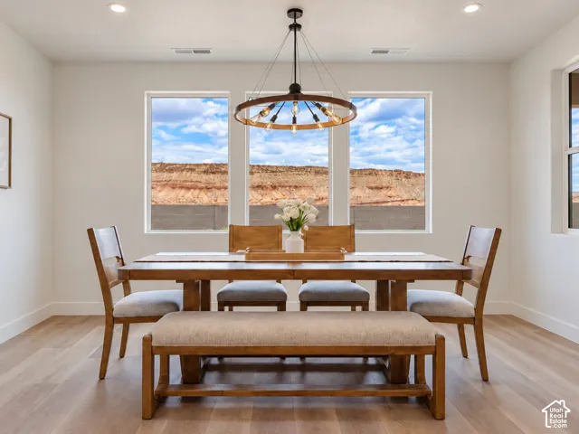 Dining area w/Large format windows with natural rock formation scenery, wood-finish flooring, with pendant chandelier