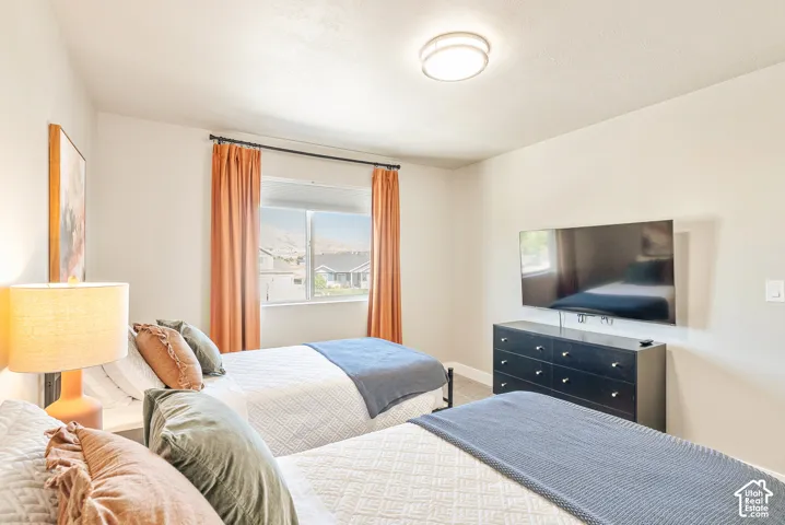 Neutral walls, flush-mount ceiling lighting, and a single-hung window