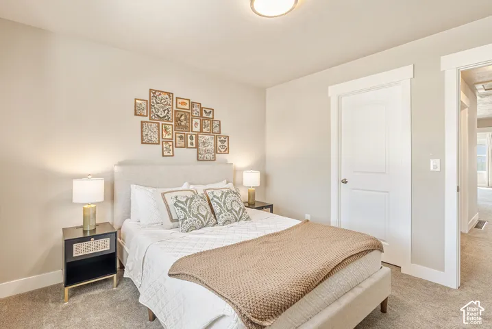 Neutral-toned walls, plush wall-to-wall carpeting, arched-panel interior door, and minimalist flush-mount ceiling lighting