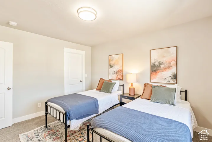 Neutral-toned room featuring neutral wall paint, carpeted flooring, two paneled interior doors, and a flush-mount ceiling light fixture