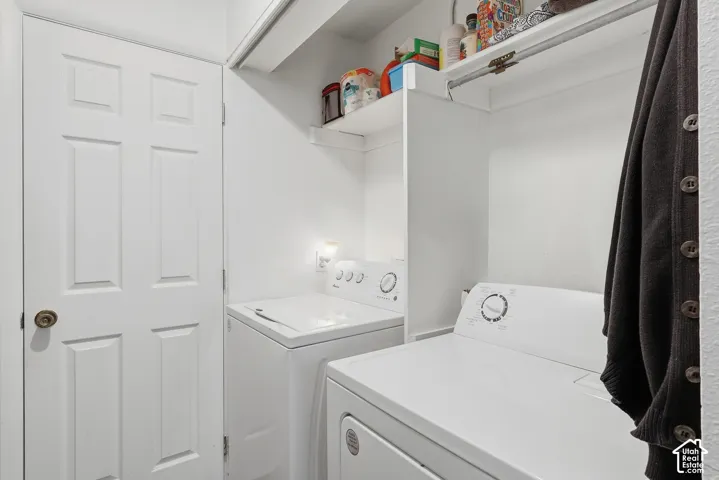 Dedicated laundry area with built-in shelving and a clothing rod