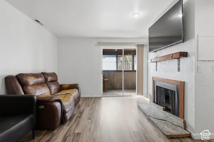 Fireplace featuring a wood mantel and stone hearth