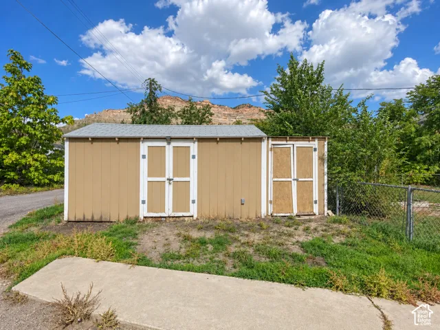 Two storage sheds with a chain link fence located in the rear of the home