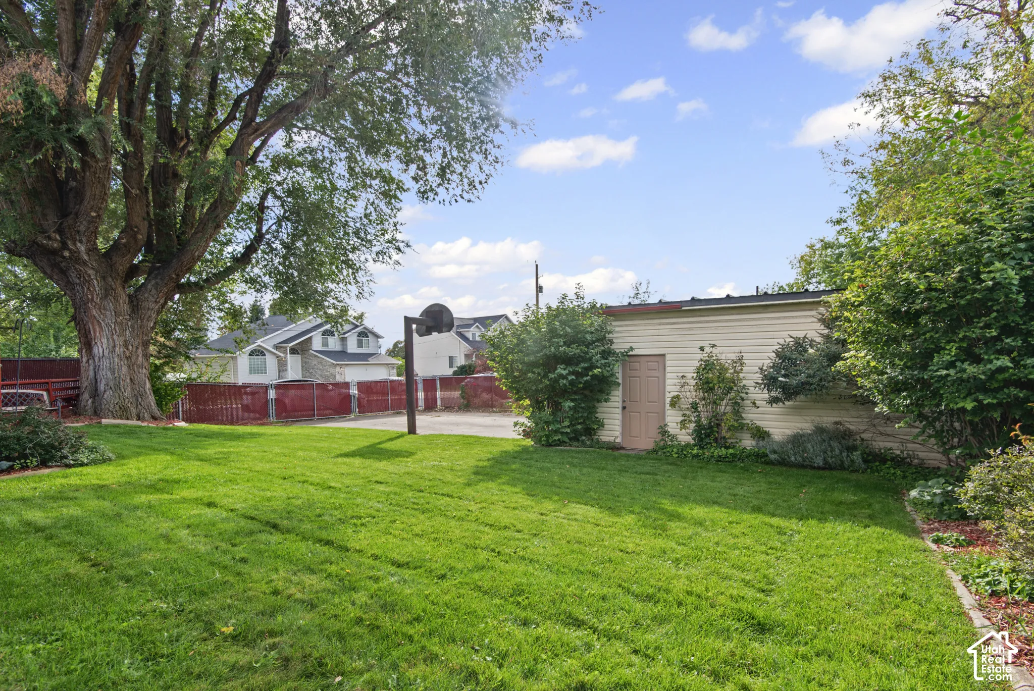 Expansive lawn area with mature trees and established landscaping