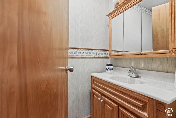 Wood-finish vanity with an integrated sink and chrome faucet