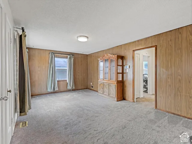 Living Room with freshly cleaned newer carpeting over the original hardwood floors