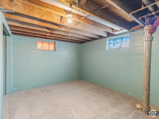 Bedroom downstairs with good headroom, carpeting, and a large closet