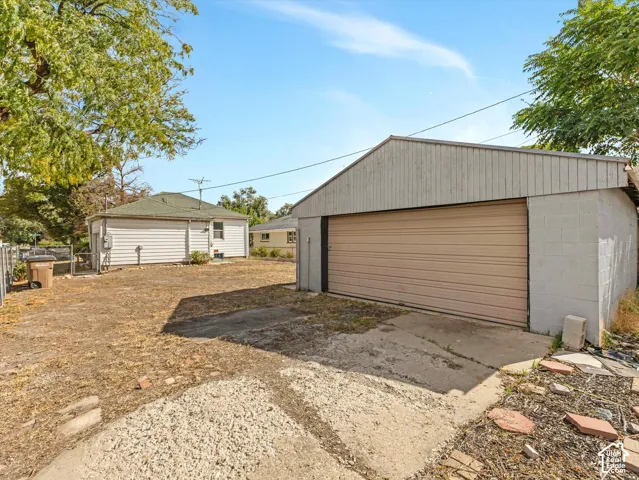 Separate detached garage has a workbench, 220 electrical service, and a separate updated electrical panel