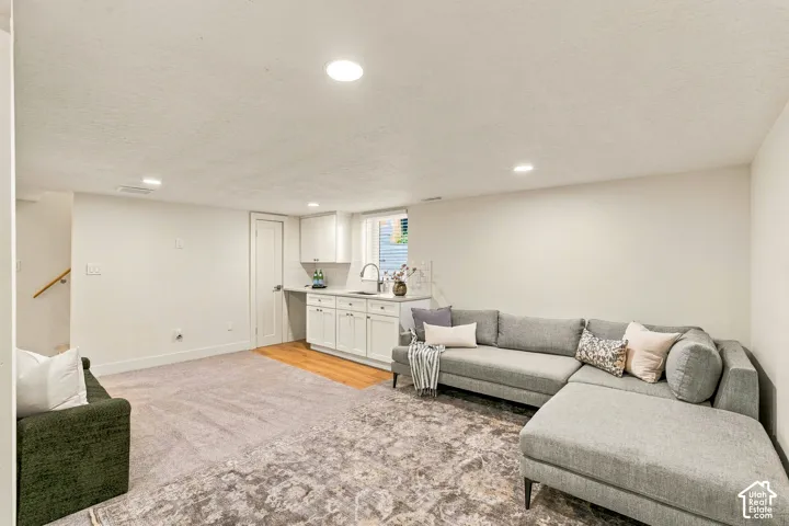 Basement Family Room with wet bar, new white shaker cabinetry and space for mini fridge, dishwasher, or stove.