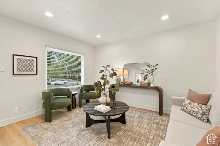Recessed lighting illuminates neutral-toned walls, complemented by wood-finish flooring