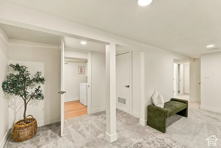 Basement Family Room with wet bar, new white shaker cabinetry and space for mini fridge, dishwasher, or stove.