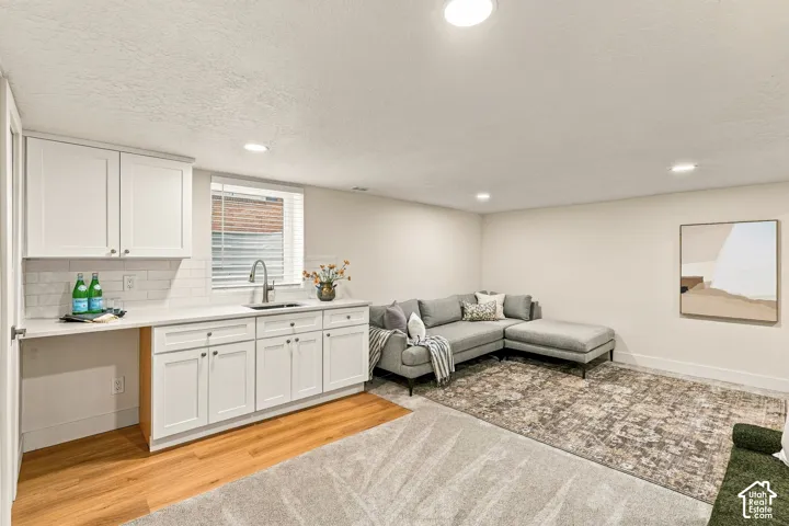 Basement Family Room with wet bar, new white shaker cabinetry and space for mini fridge, dishwasher, or stove.
