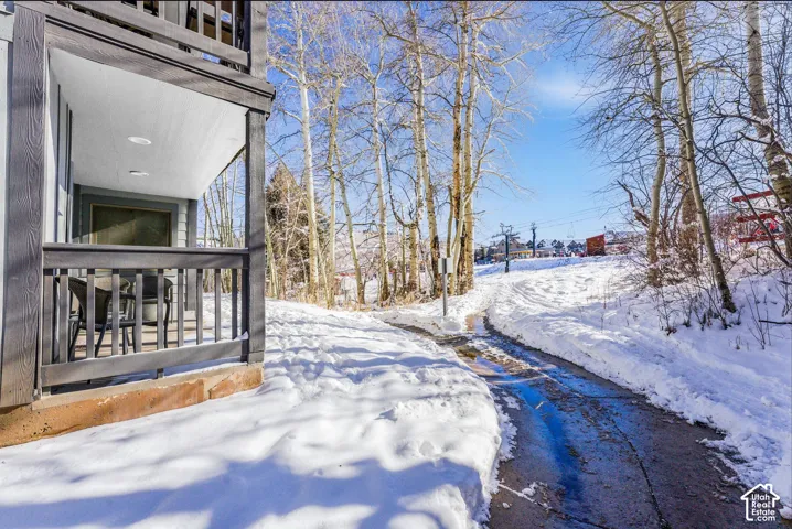 Covered outdoor patio with dark wood-finish railings