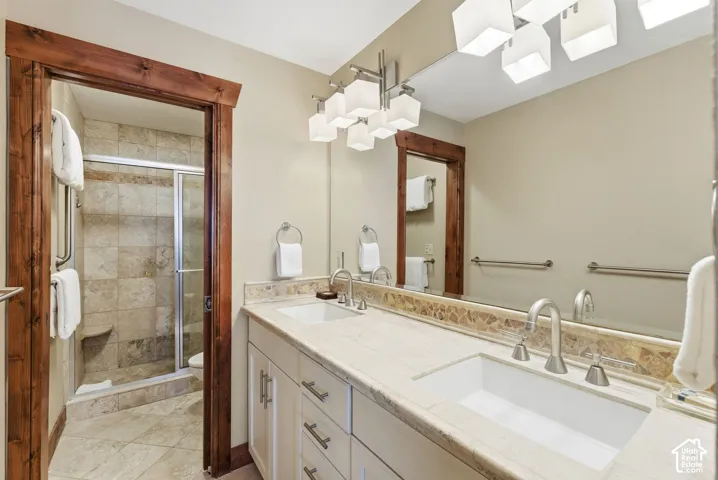 Dual vanity with integrated sinks, stone countertops, and brushed nickel fixtures