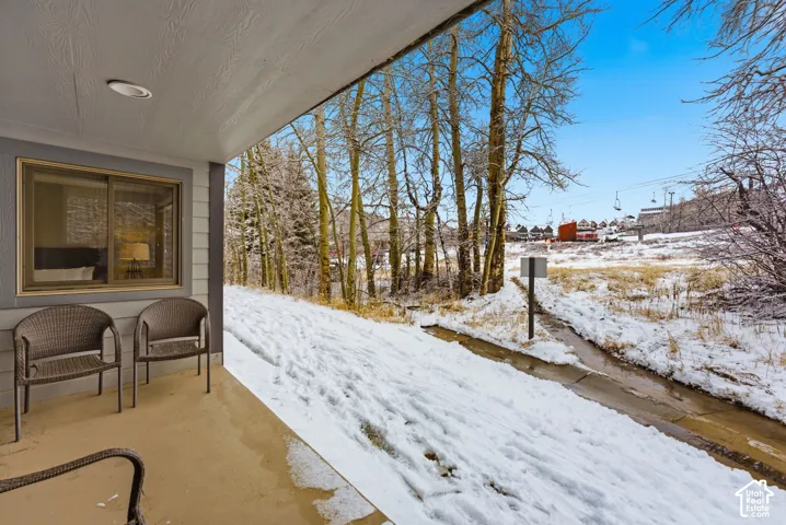 Covered patio with recessed lighting, offering exterior access and a window to interior space