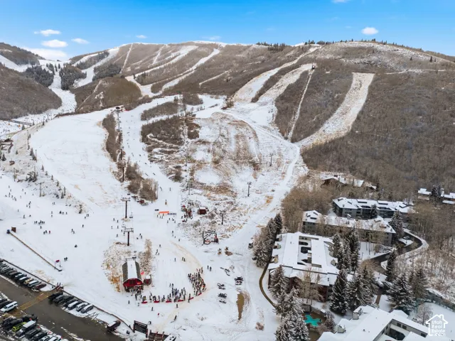 Snow-covered mountain terrain featuring multiple ski trails and chairlifts