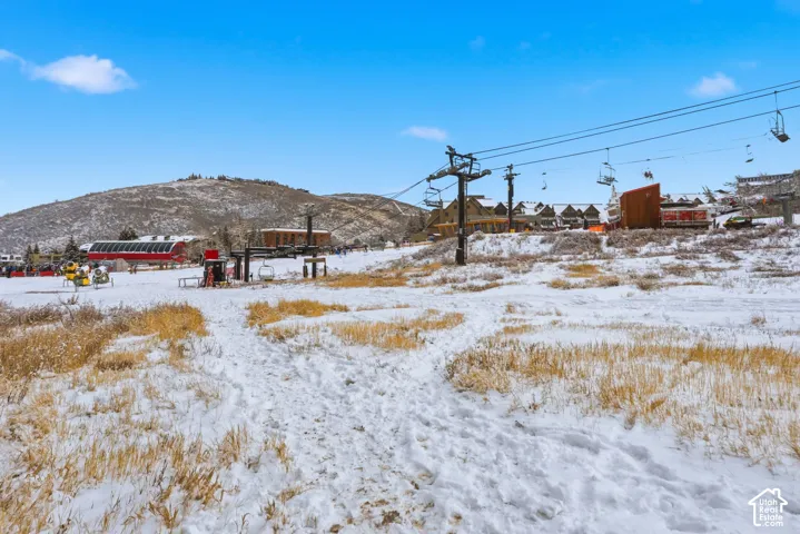 Snow-covered terrain with distant mountainous backdrop