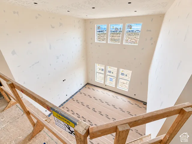 Double-height ceiling, floor-to-ceiling windows, and recessed lighting