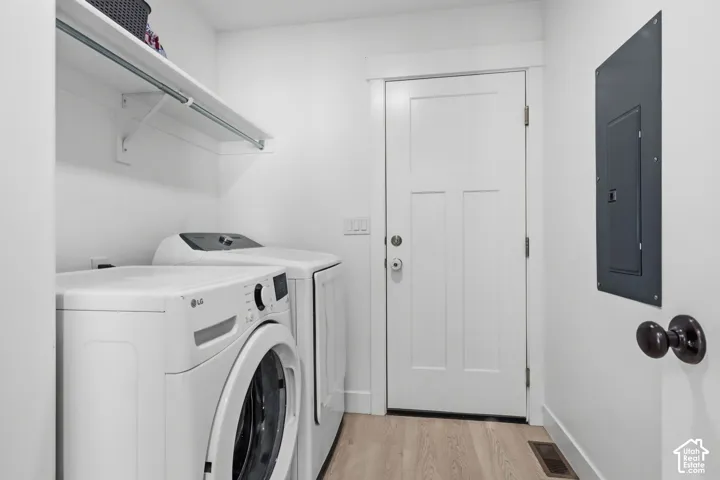 Laundry located off garage entrance and built-in shelving with an integrated clothes rod