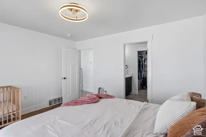 Master Bedroom featuring a circular flush-mount light fixture, multi-panel interior doors, and a walk-in closet